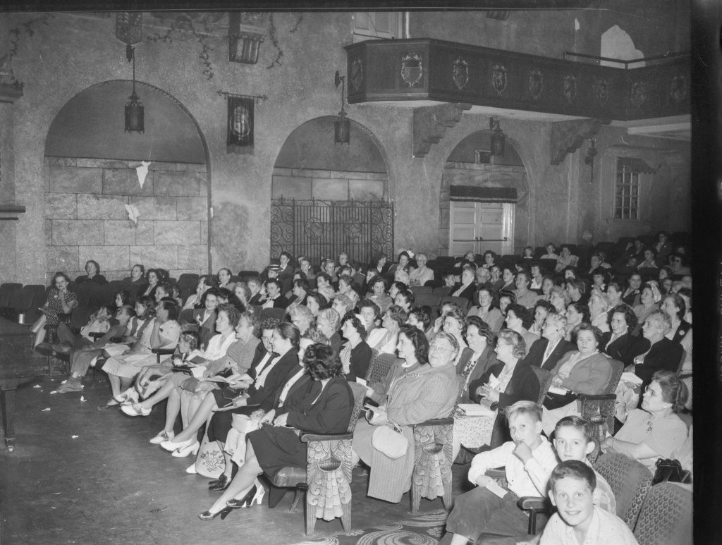 Audience watching show at theater